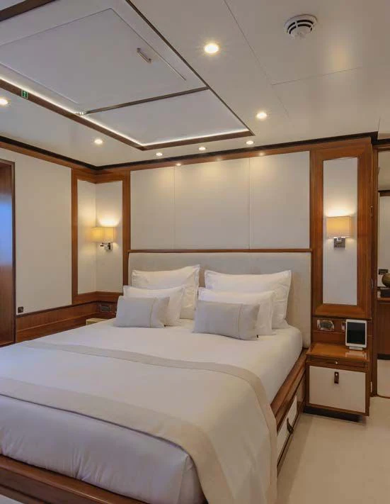a bed with white sheets aboard NEW WAVES Yacht for Sale
