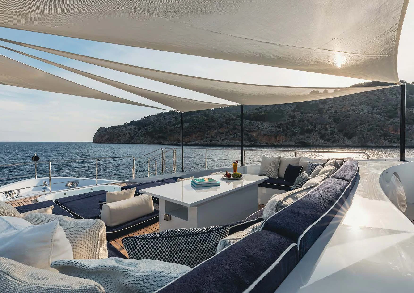 a large white tent with a couch and a table and chairs aboard NEW WAVES Yacht for Sale