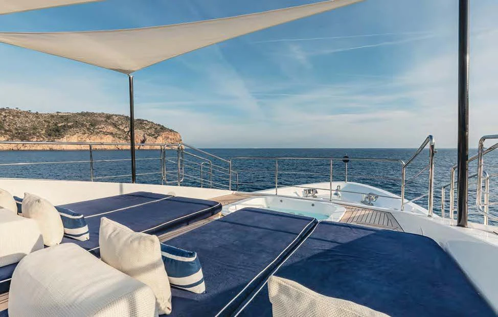 a large pool with a view of the ocean and mountains aboard NEW WAVES Yacht for Sale