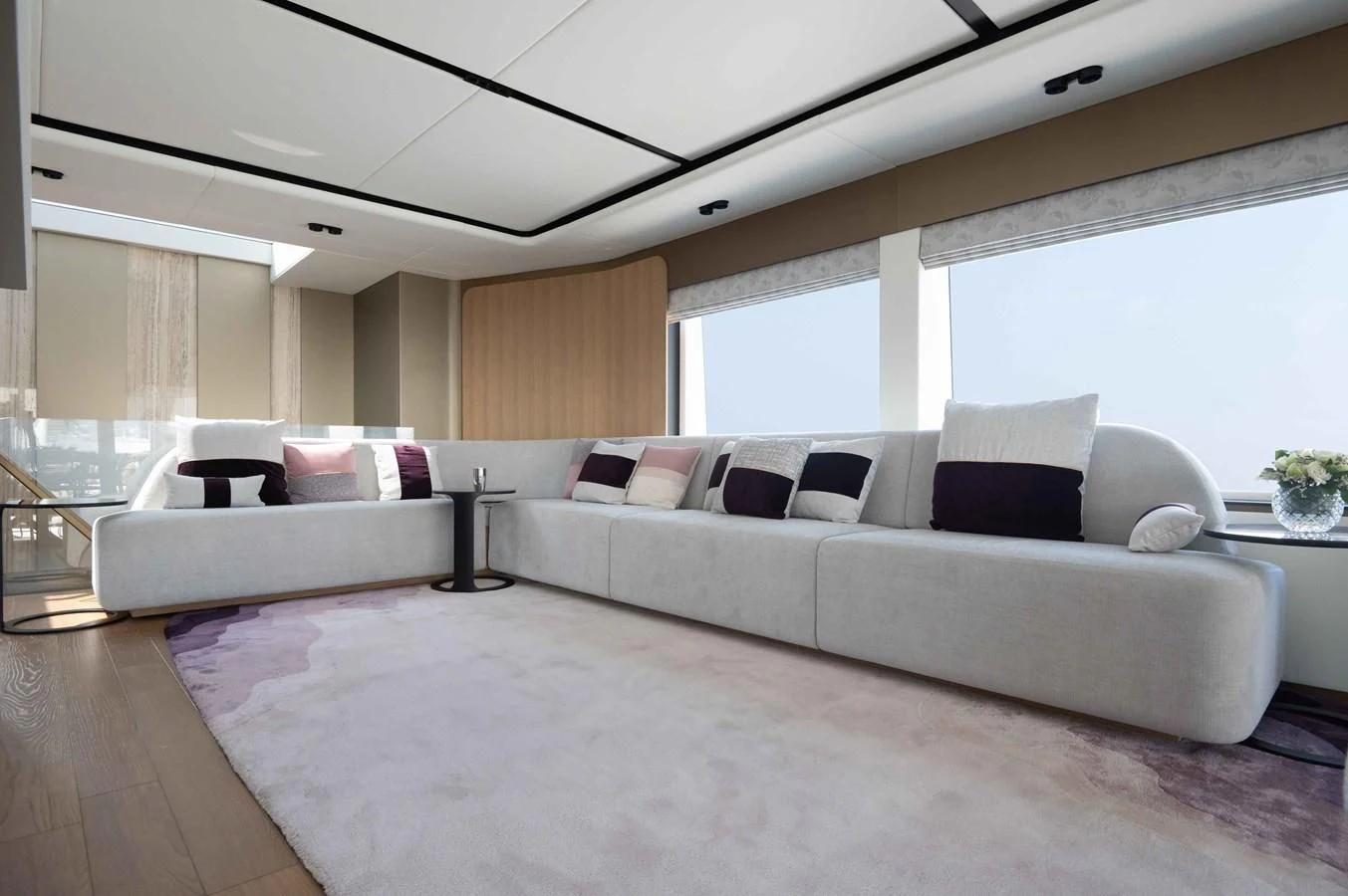 a large living room with a large white couch and a large window aboard ALKHADRA Yacht for Charter