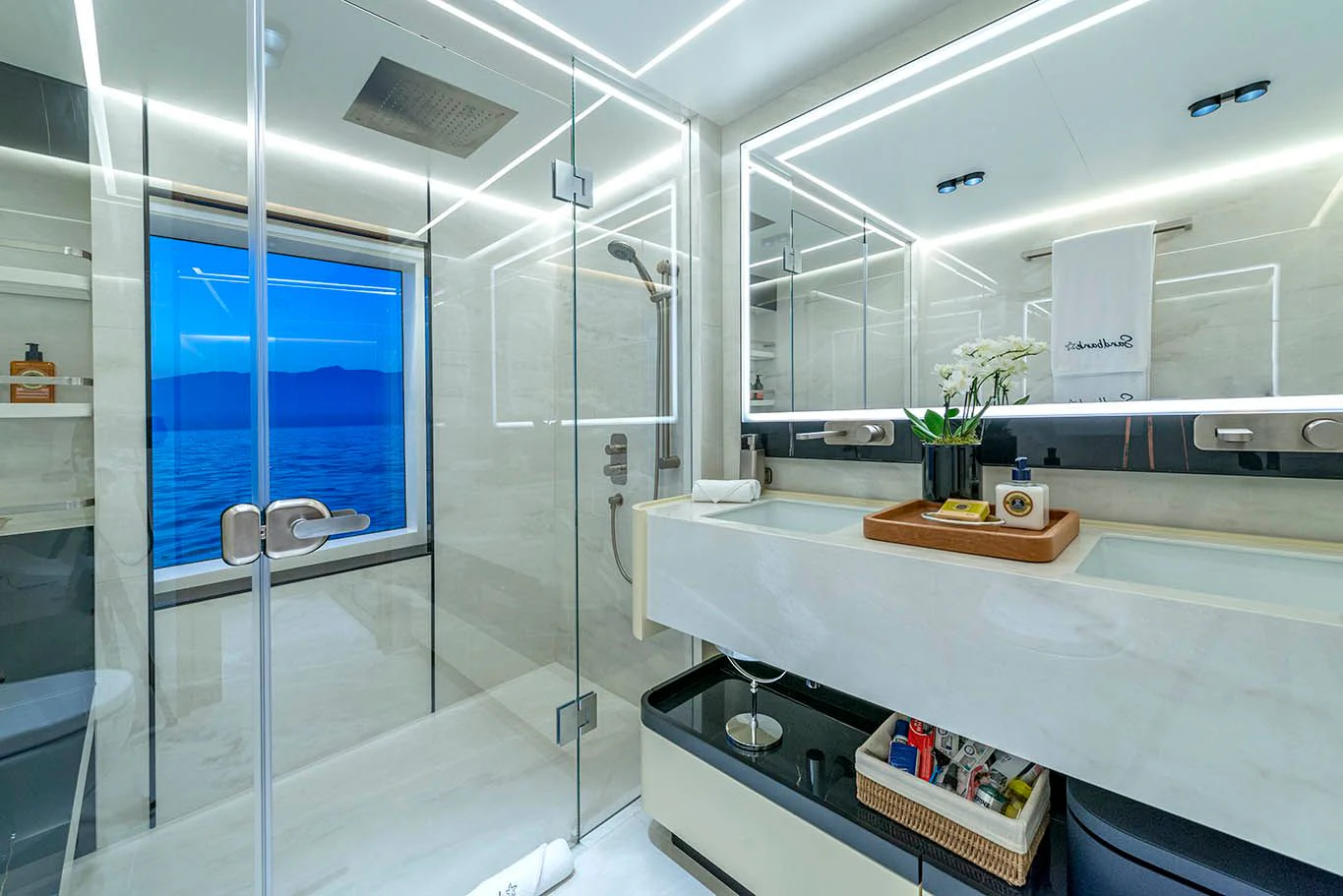a bathroom with a glass shower aboard ALKHADRA Yacht for Charter