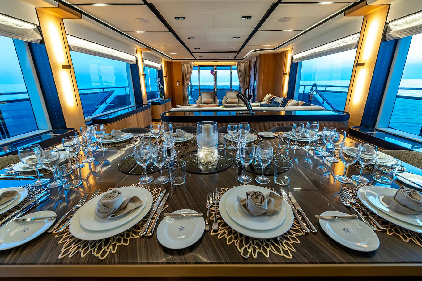 a large table with plates and glasses aboard ALKHADRA Yacht for Charter