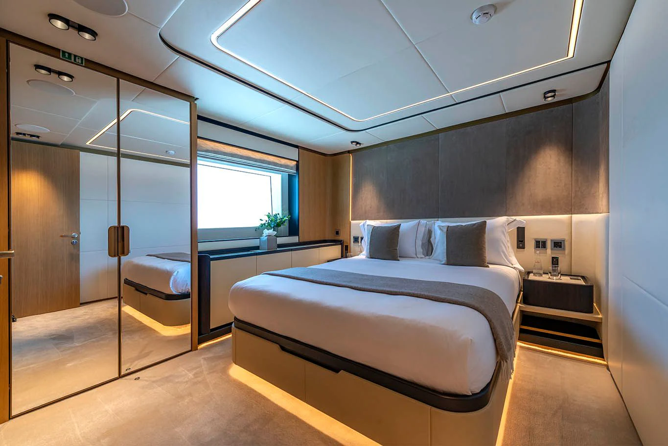 a room with a bed and a glass door aboard ALKHADRA Yacht for Charter