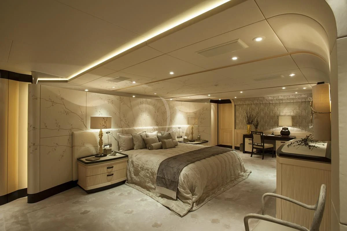 a large bedroom with a bed and a desk aboard SEA RHAPSODY Yacht for Sale