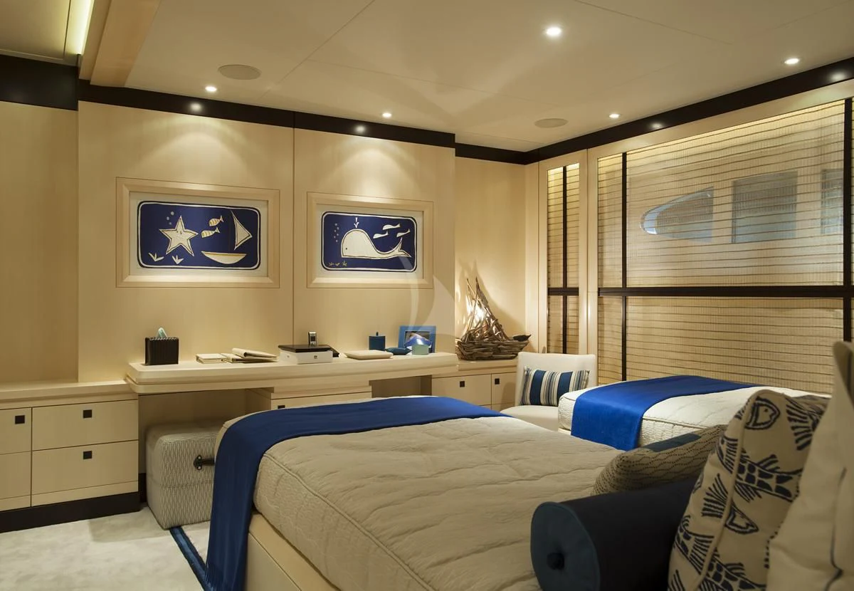 a bedroom with a desk and a bed aboard SEA RHAPSODY Yacht for Sale