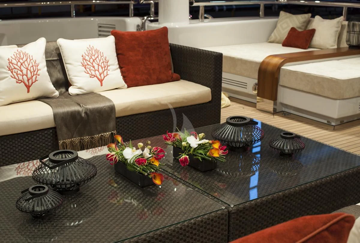a table with flowers and pillows aboard SEA RHAPSODY Yacht for Sale