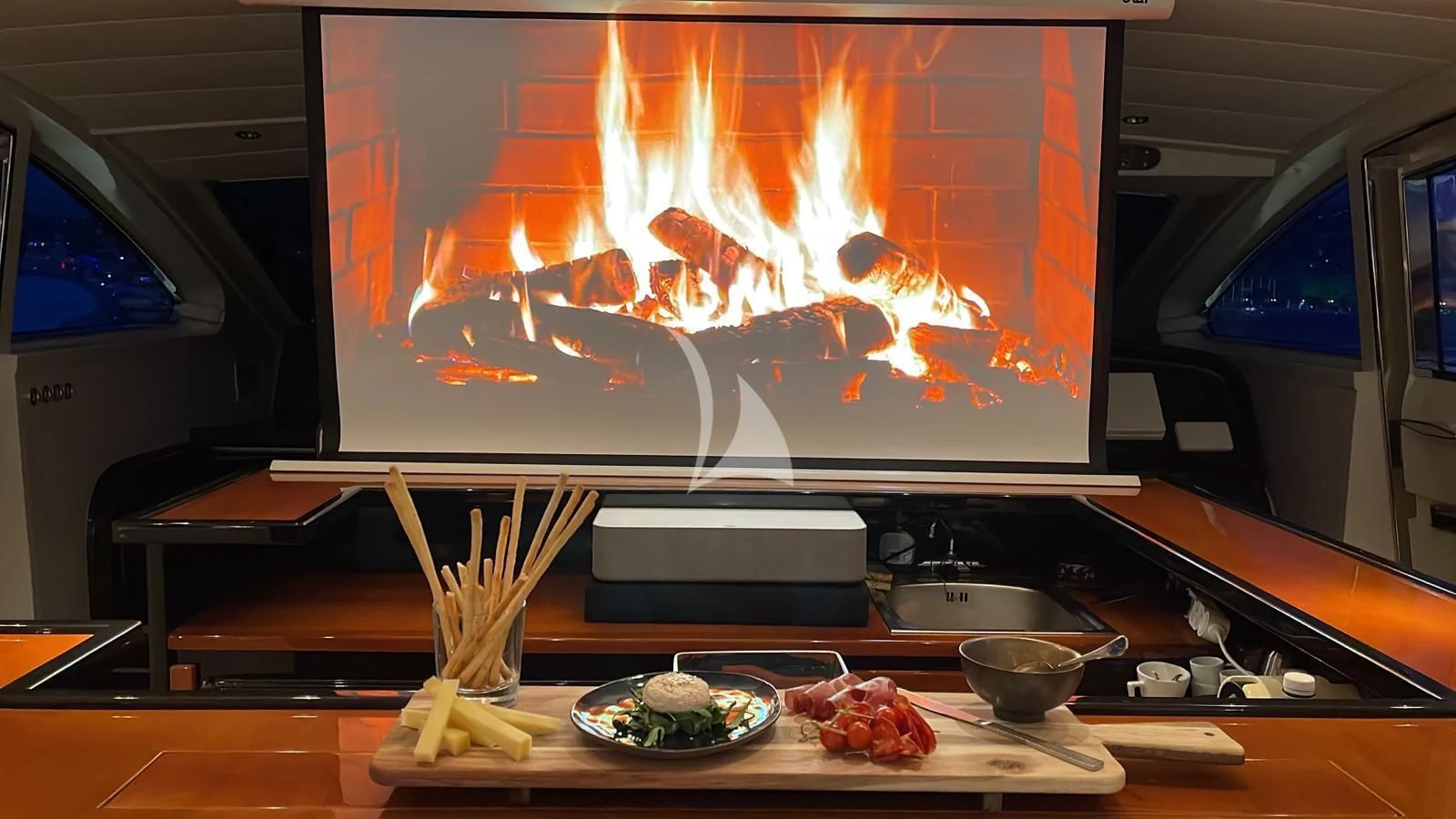 a television screen on a table aboard NOTORIOUS Yacht for Sale