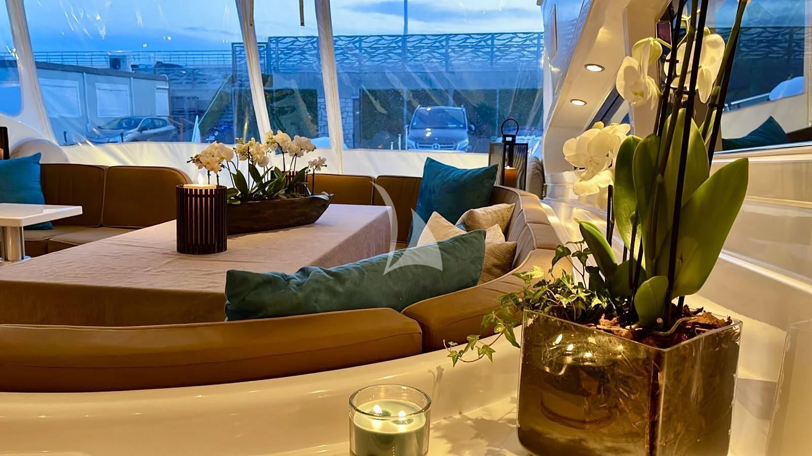 a room with a plant and a table with chairs and a window aboard NOTORIOUS Yacht for Sale