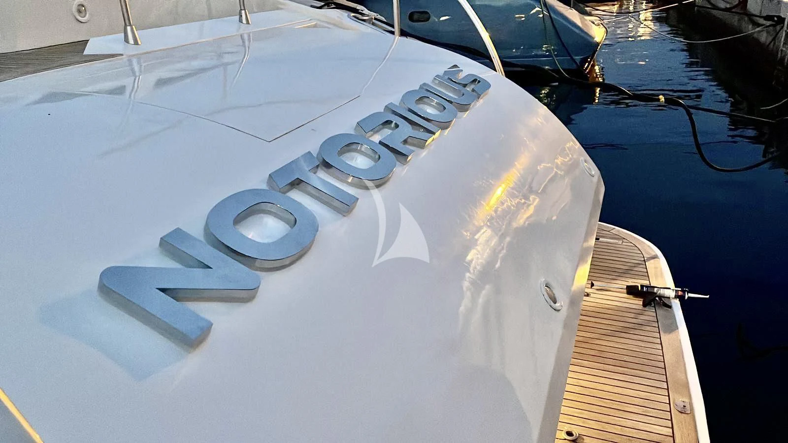 a white and black model of a ship on a blue surface aboard NOTORIOUS Yacht for Sale