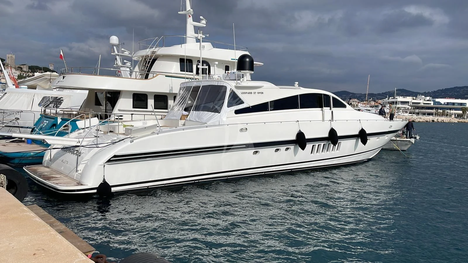 a white yacht docked at a pier aboard NOTORIOUS Yacht for Sale