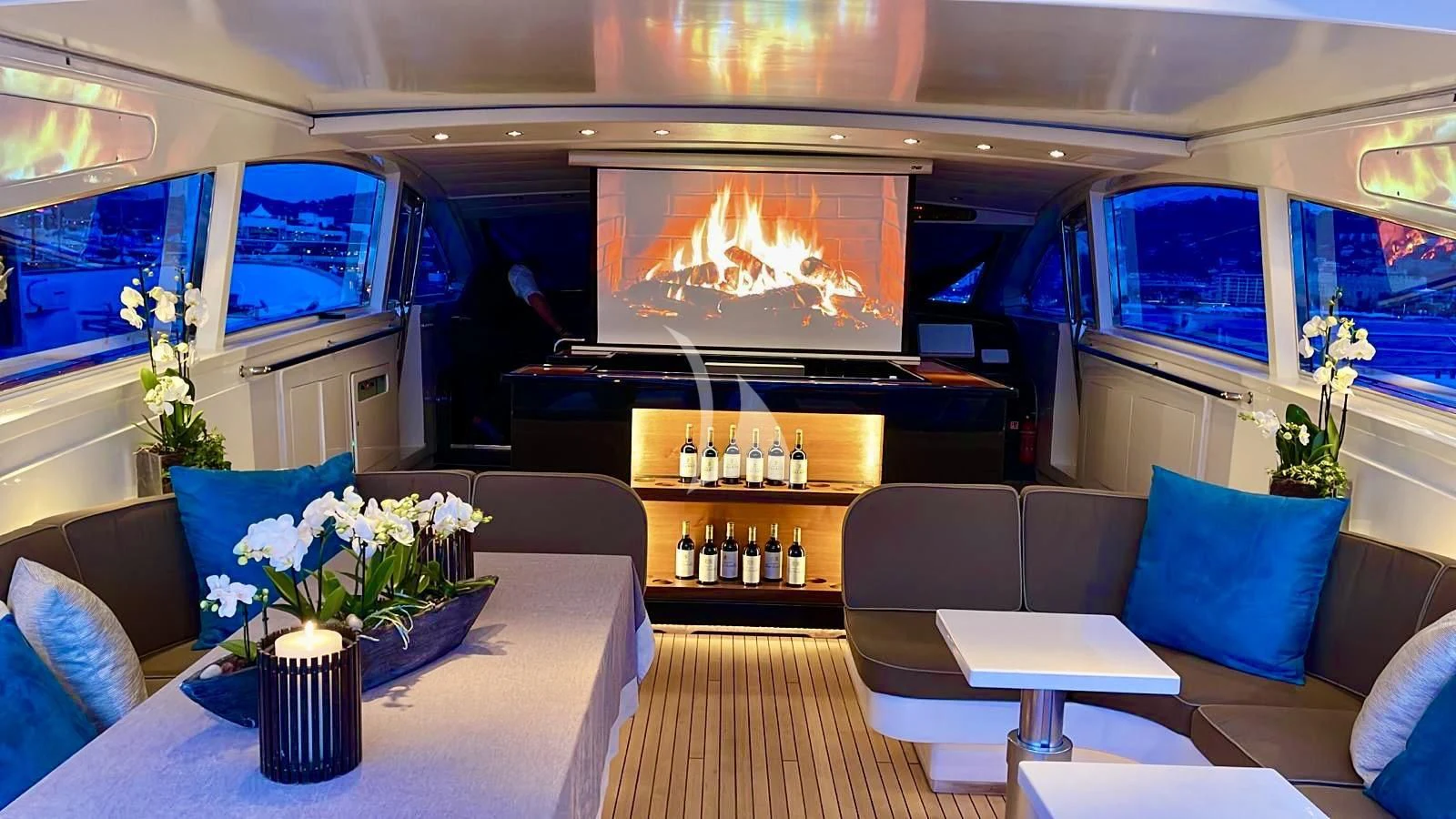 a room with a table chairs and a television aboard NOTORIOUS Yacht for Sale