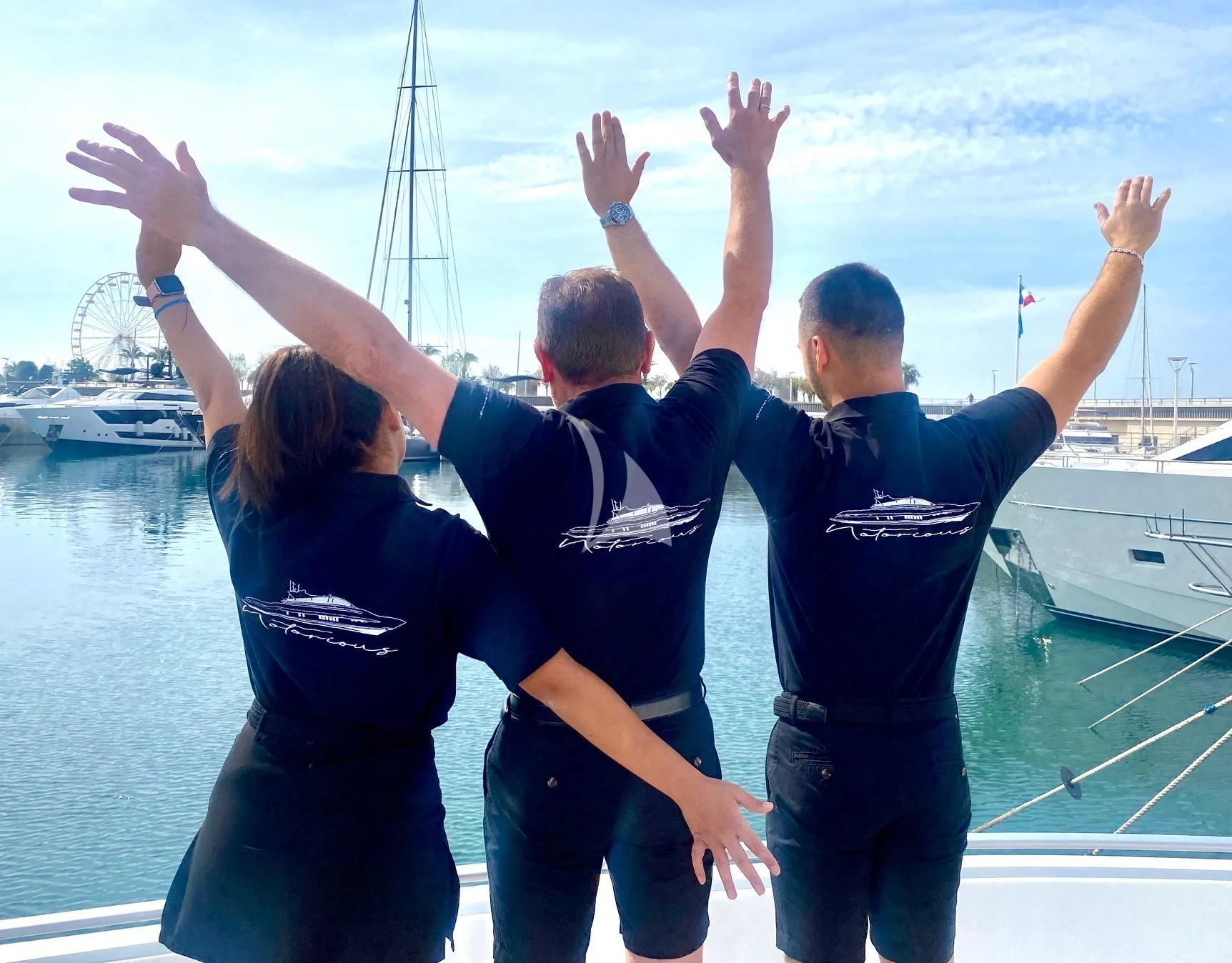 a group of people raising their hands aboard NOTORIOUS Yacht for Sale