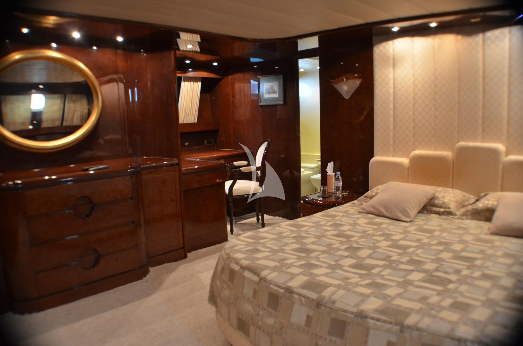 a hotel room with a bed and a mirror aboard MISS CANDY Yacht for Charter