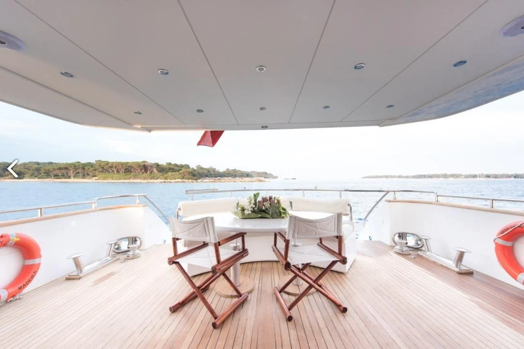 a table and chairs on a deck aboard MISS CANDY Yacht for Charter