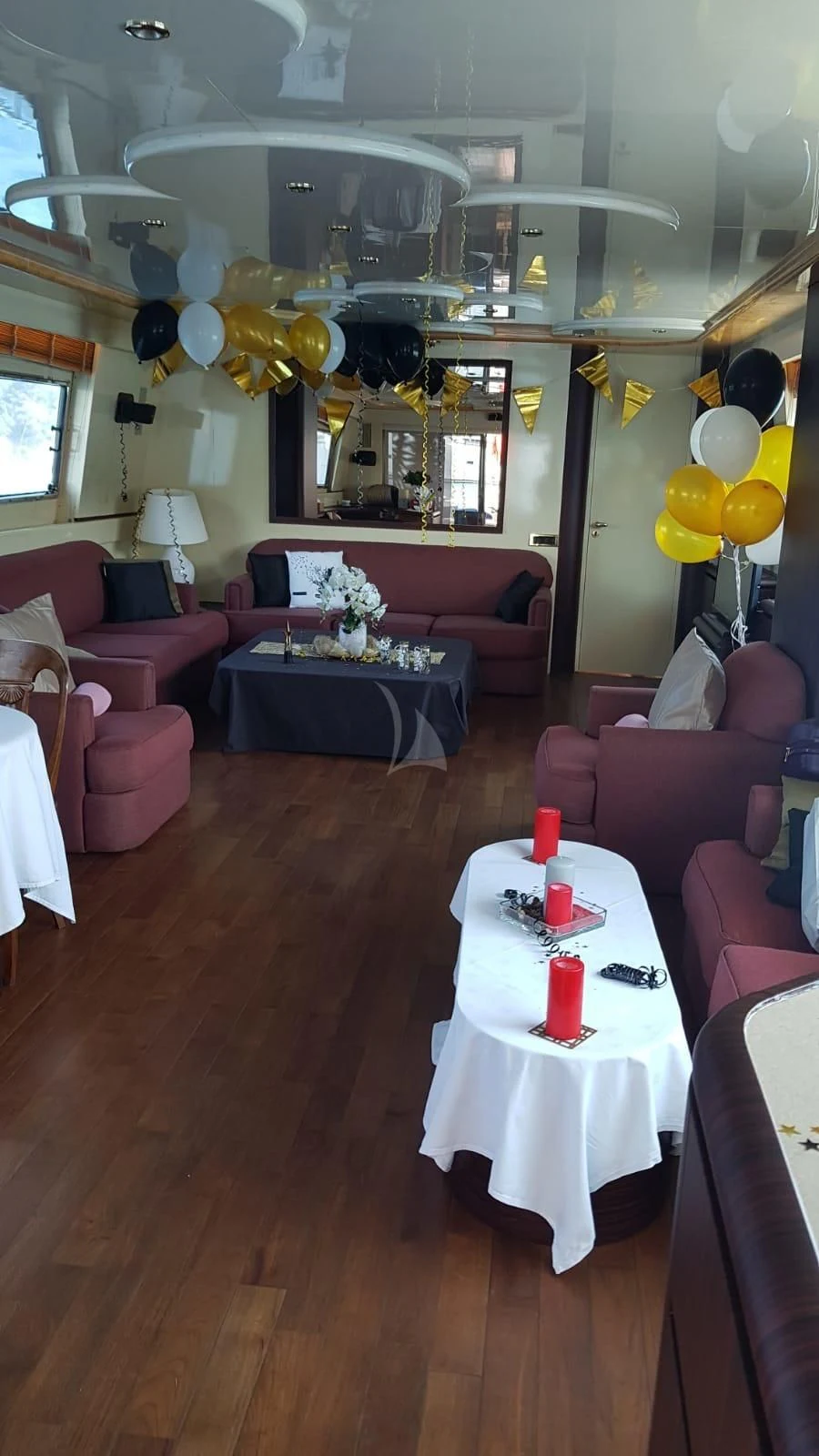 a room with balloons and tables aboard MISS CANDY Yacht for Charter