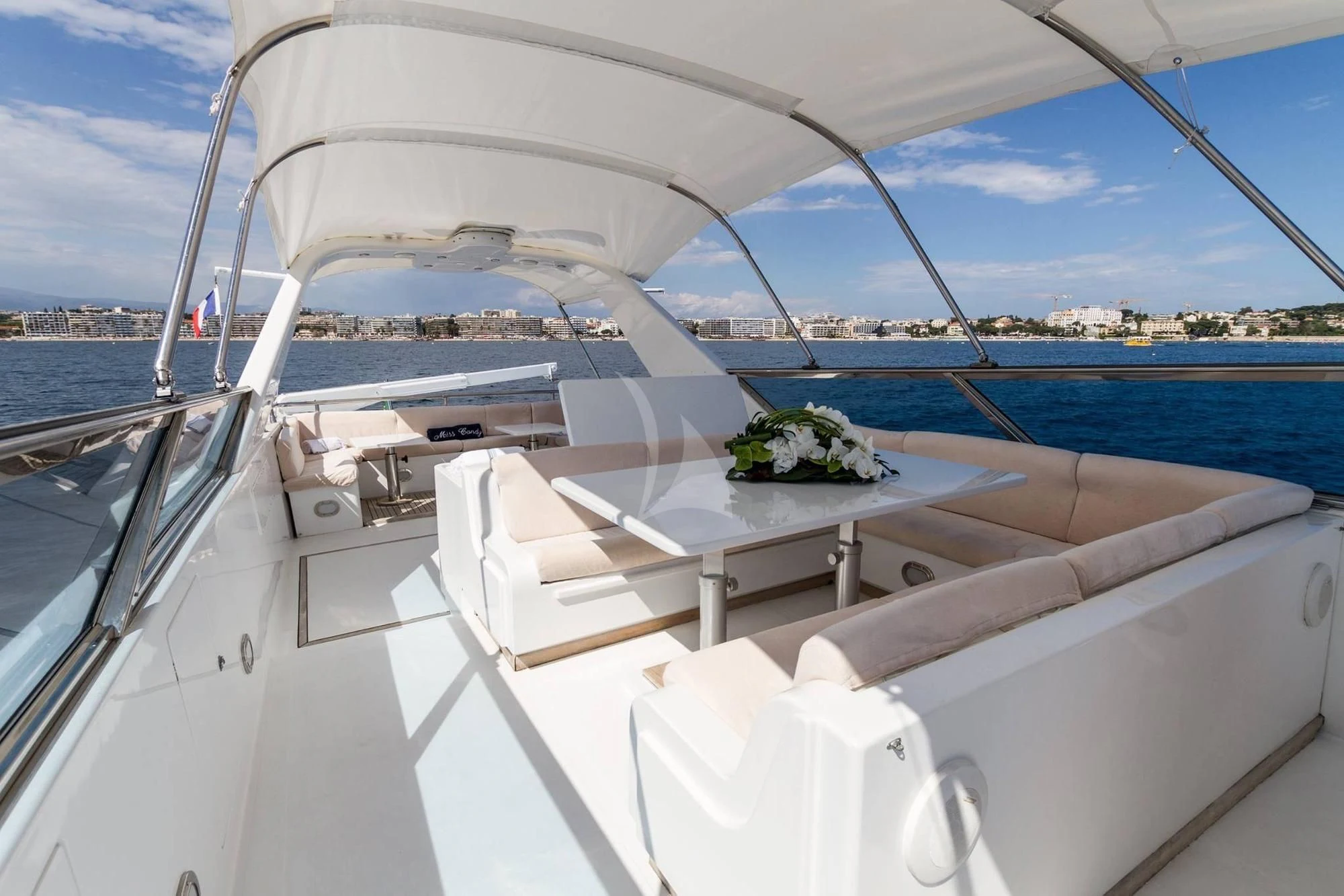 a white boat with a table and chairs on it aboard MISS CANDY Yacht for Charter