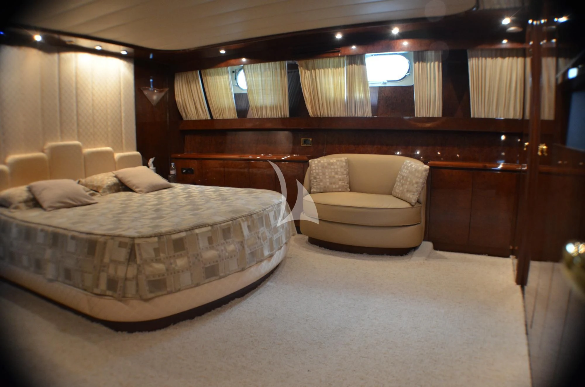 a bed and a chair in a room aboard MISS CANDY Yacht for Charter