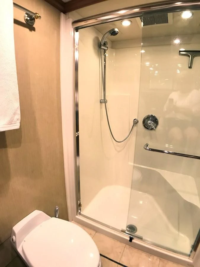 a bathroom with a shower and toilet aboard HARBOR LADY Yacht for Sale