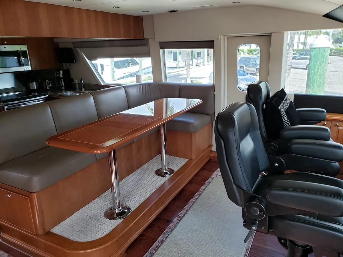 a room with a table and chairs aboard HARBOR LADY Yacht for Sale