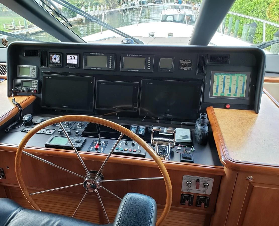 a wooden table with a radio and a wooden chair aboard HARBOR LADY Yacht for Sale