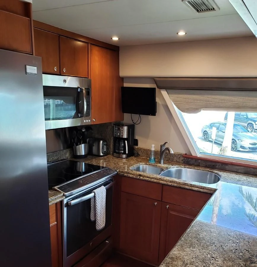 a kitchen with a stainless steel refrigerator aboard HARBOR LADY Yacht for Sale
