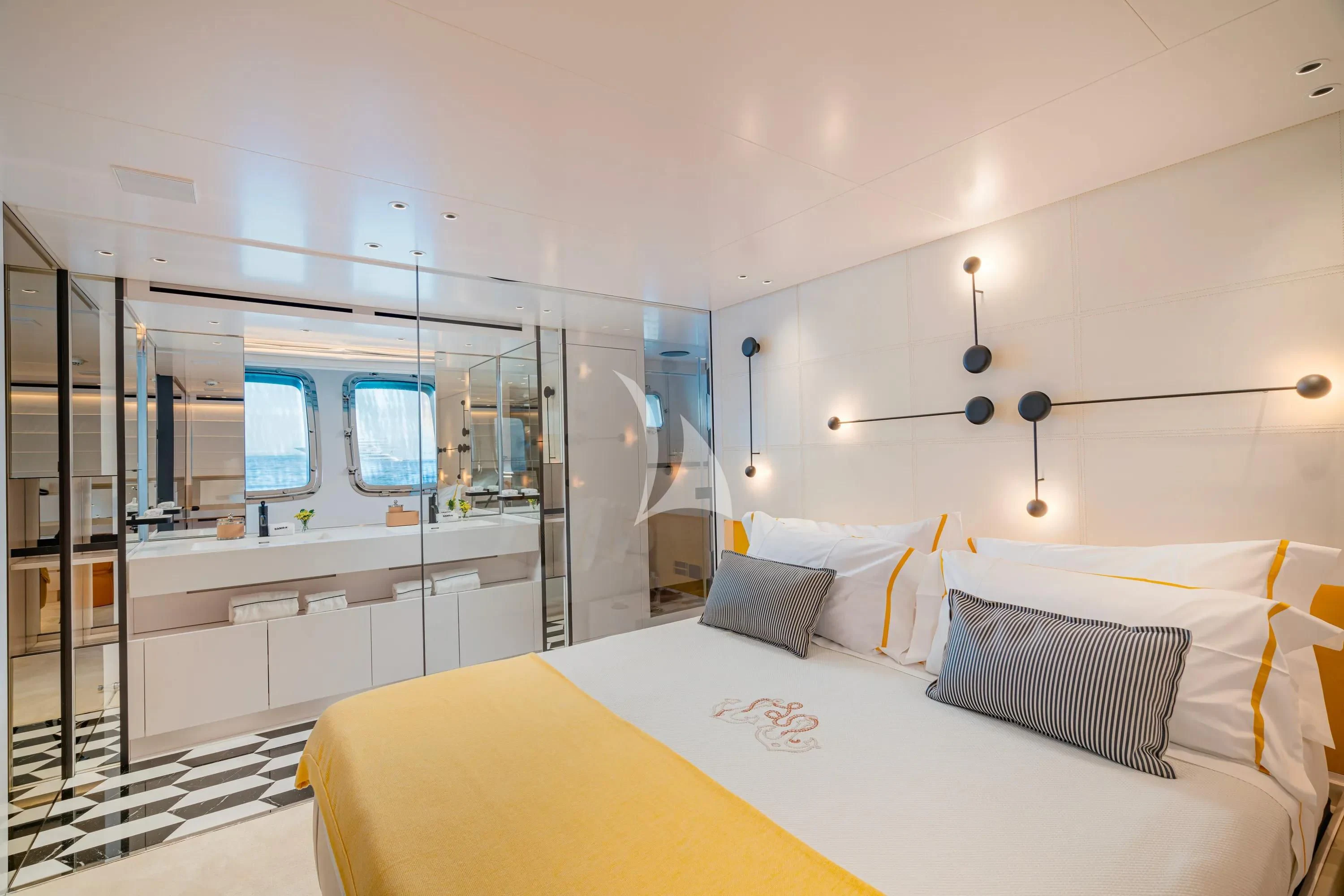 a bedroom with a bed and a mirror aboard DANIDA Yacht for Charter