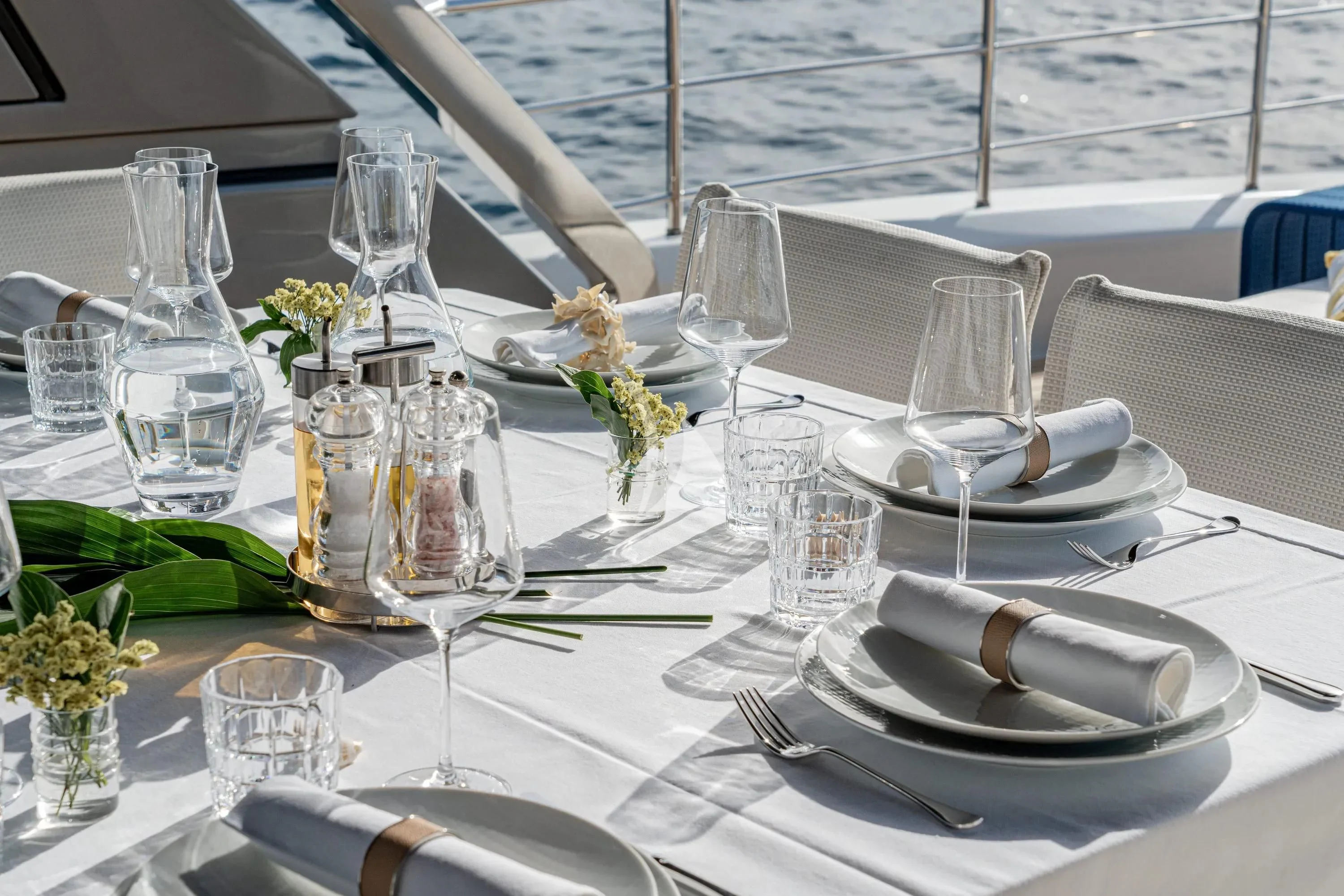 a table set with silverware and glasses aboard DANIDA Yacht for Charter