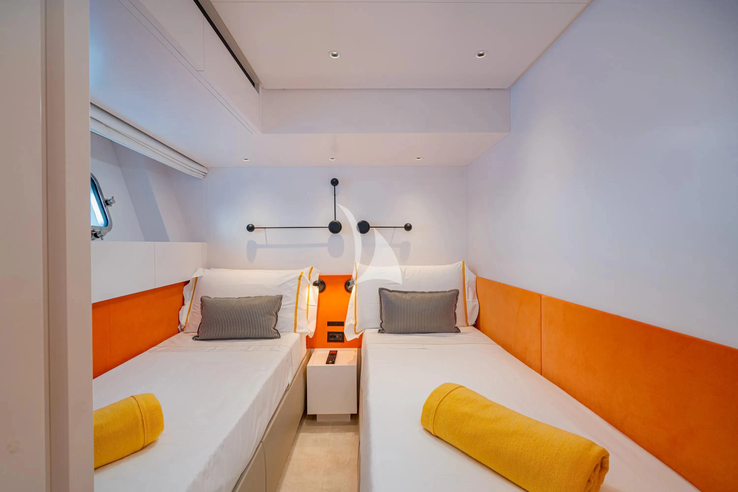 a room with a bed and a desk aboard DANIDA Yacht for Charter