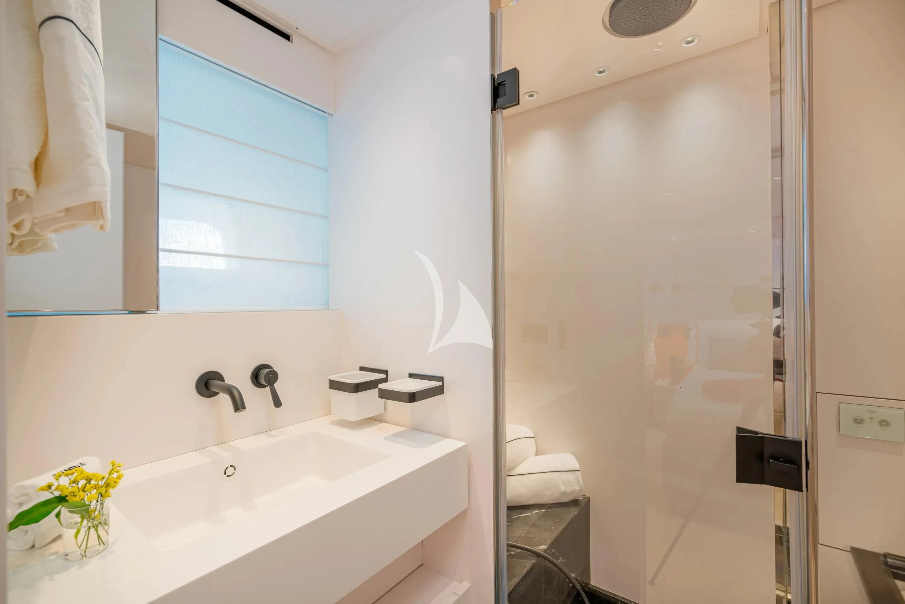 a bathroom with a glass shower aboard DANIDA Yacht for Charter