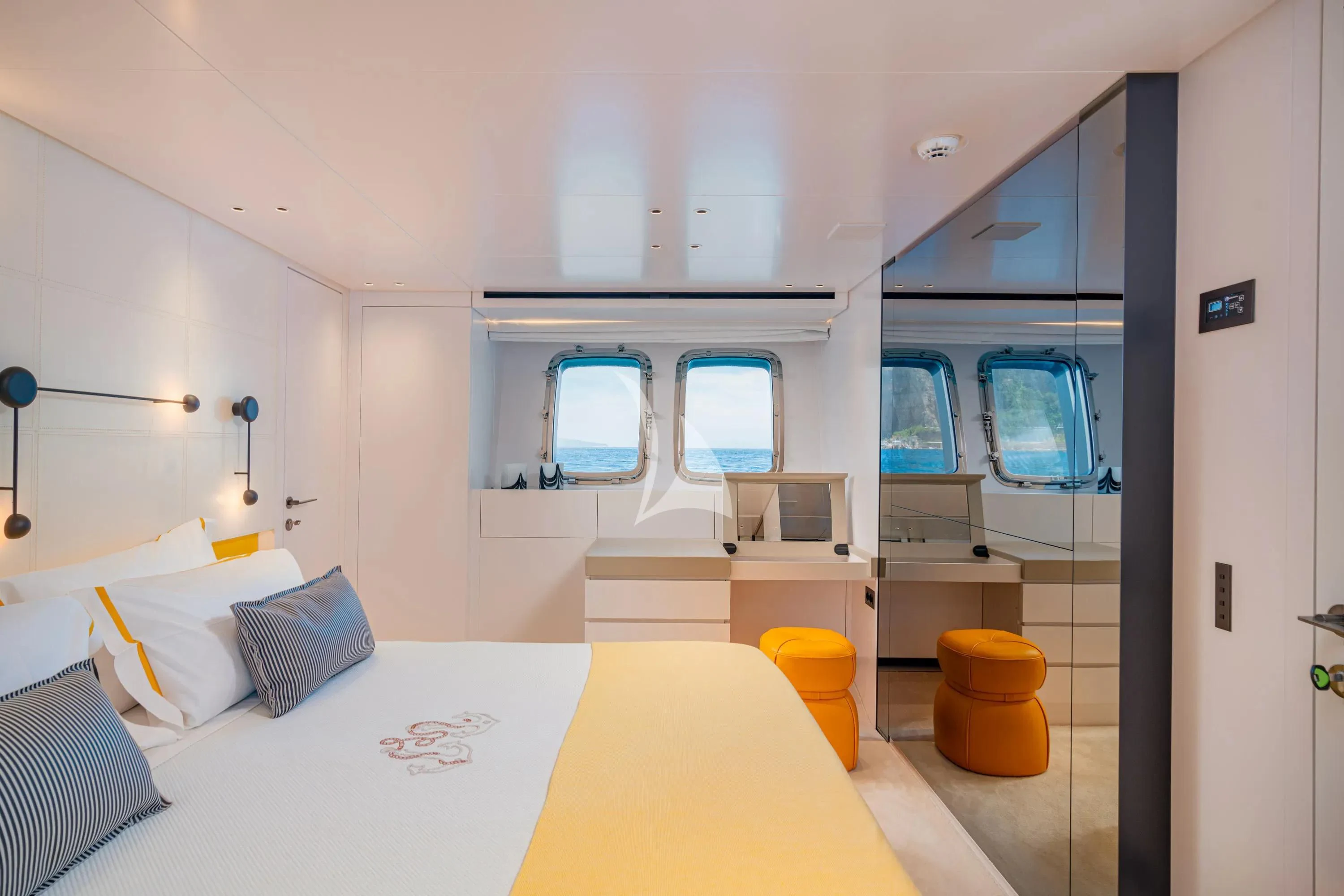 a bedroom with a bed and a desk aboard DANIDA Yacht for Charter