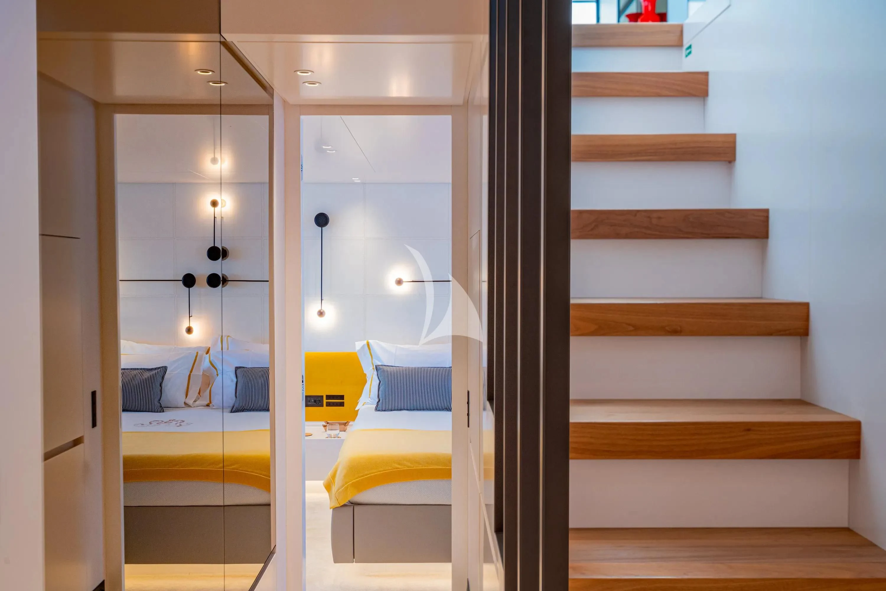 a room with a bed and a mirror aboard DANIDA Yacht for Charter