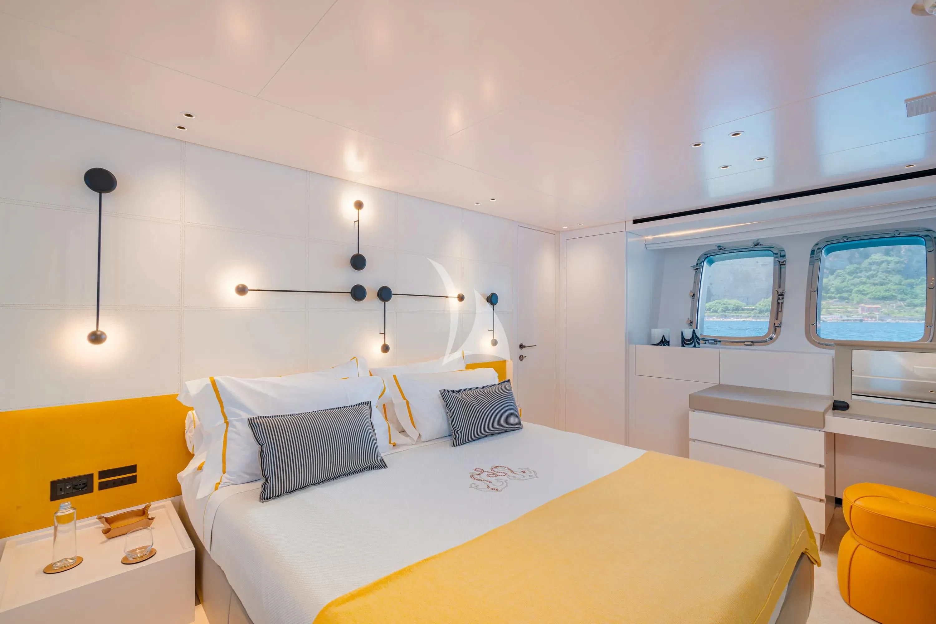 a bedroom with a bed and a desk aboard DANIDA Yacht for Charter