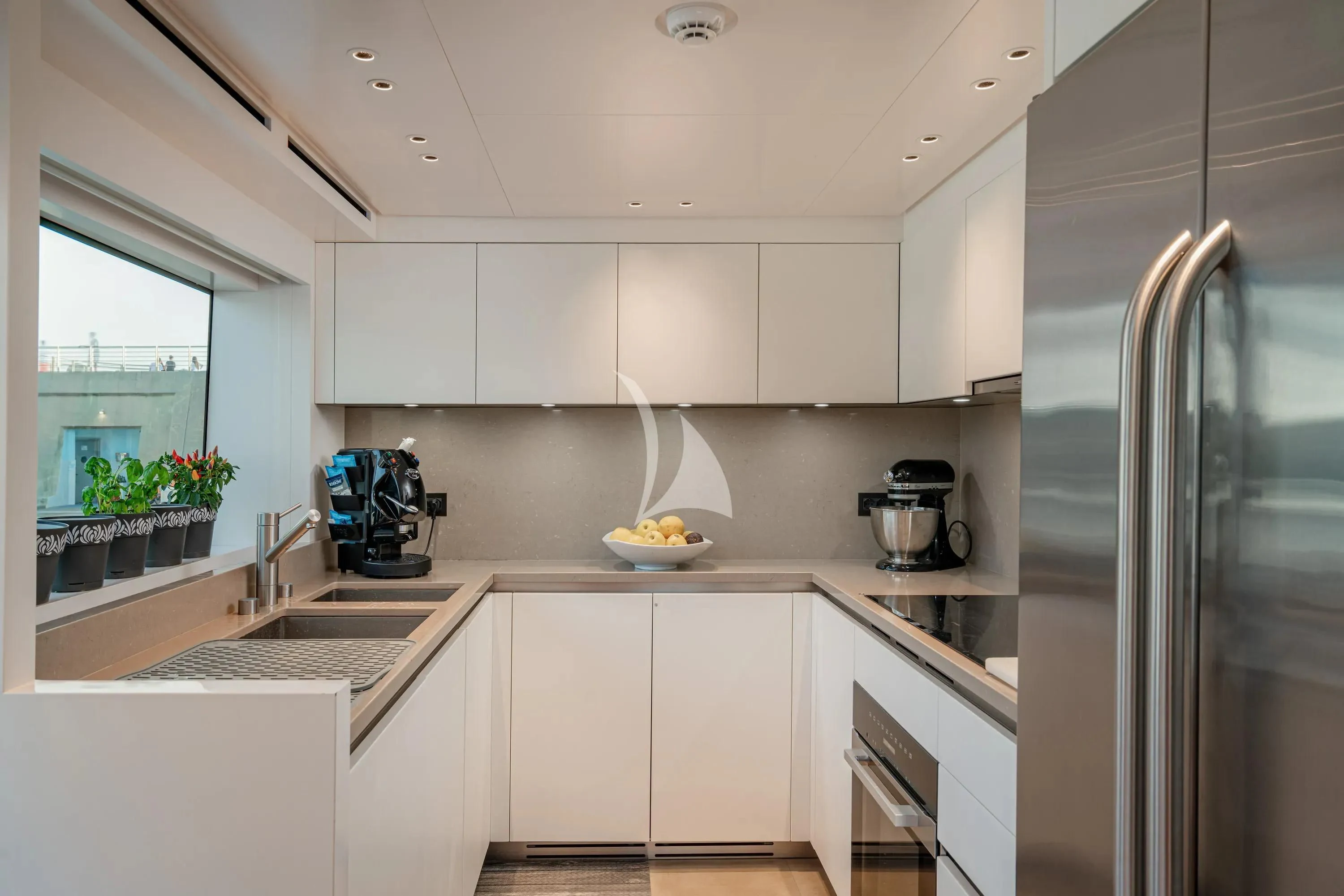 a kitchen with white cabinets aboard DANIDA Yacht for Charter