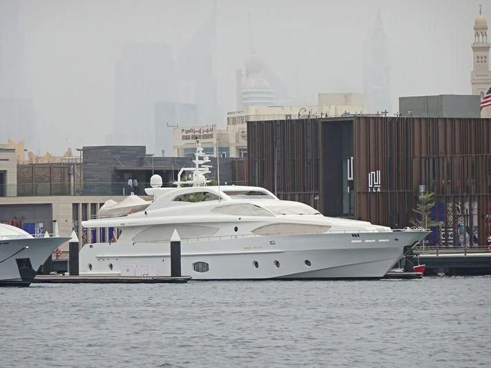 a large white boat in a harbor aboard AL SHMOOKH Yacht for Sale