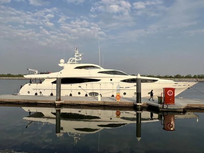 a white yacht docked at a dock aboard AL SHMOOKH Yacht for Sale