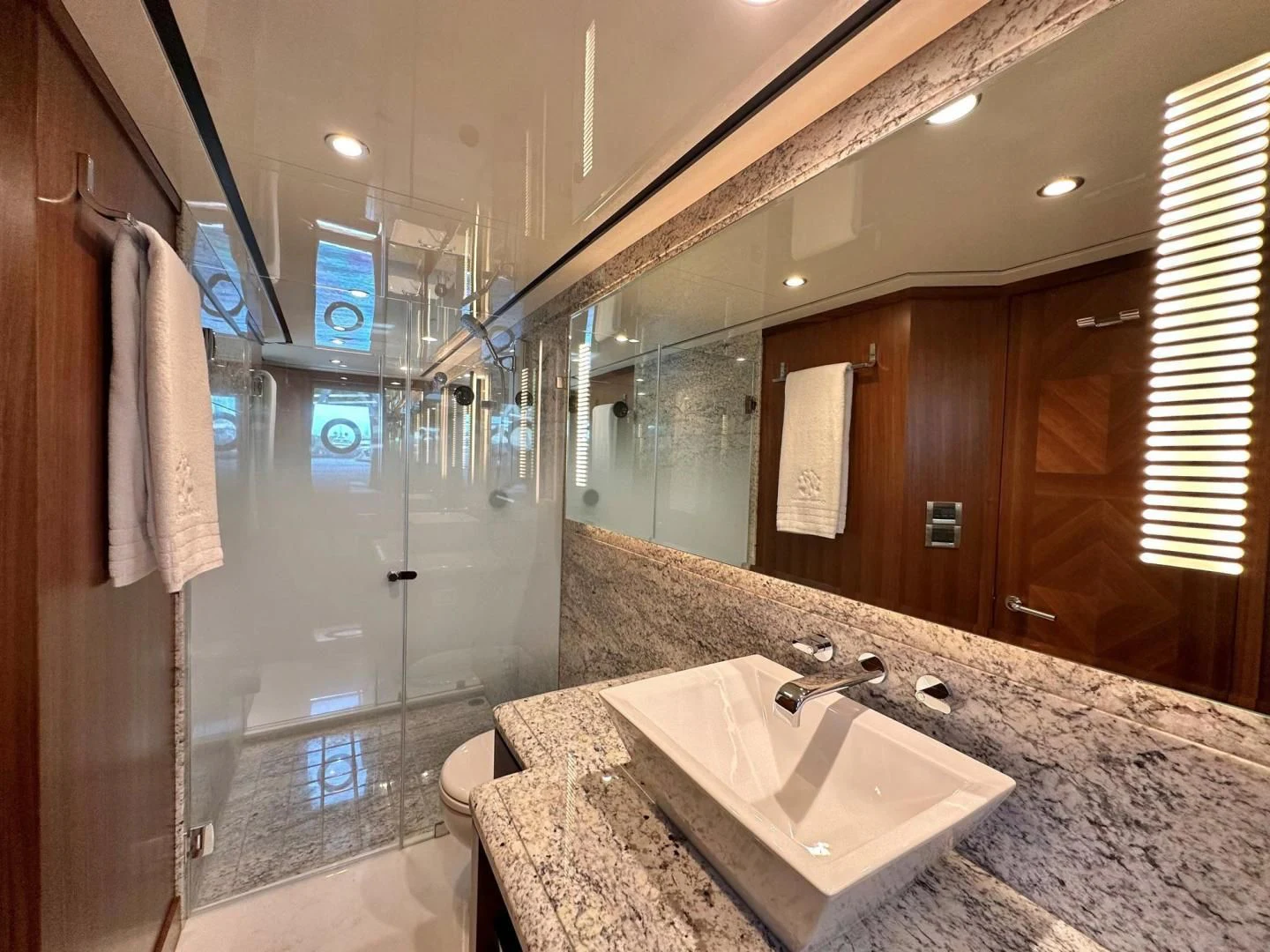 a bathroom with a marble countertop aboard CRUMDALE Yacht for Sale