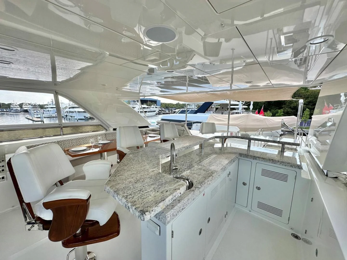 a room with tables chairs and a large window aboard CRUMDALE Yacht for Sale
