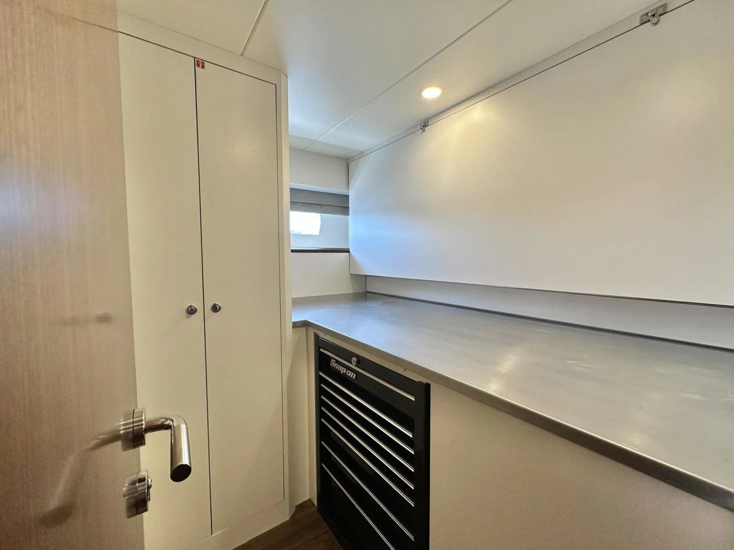a kitchen with a refrigerator and cabinets aboard CRUMDALE Yacht for Sale