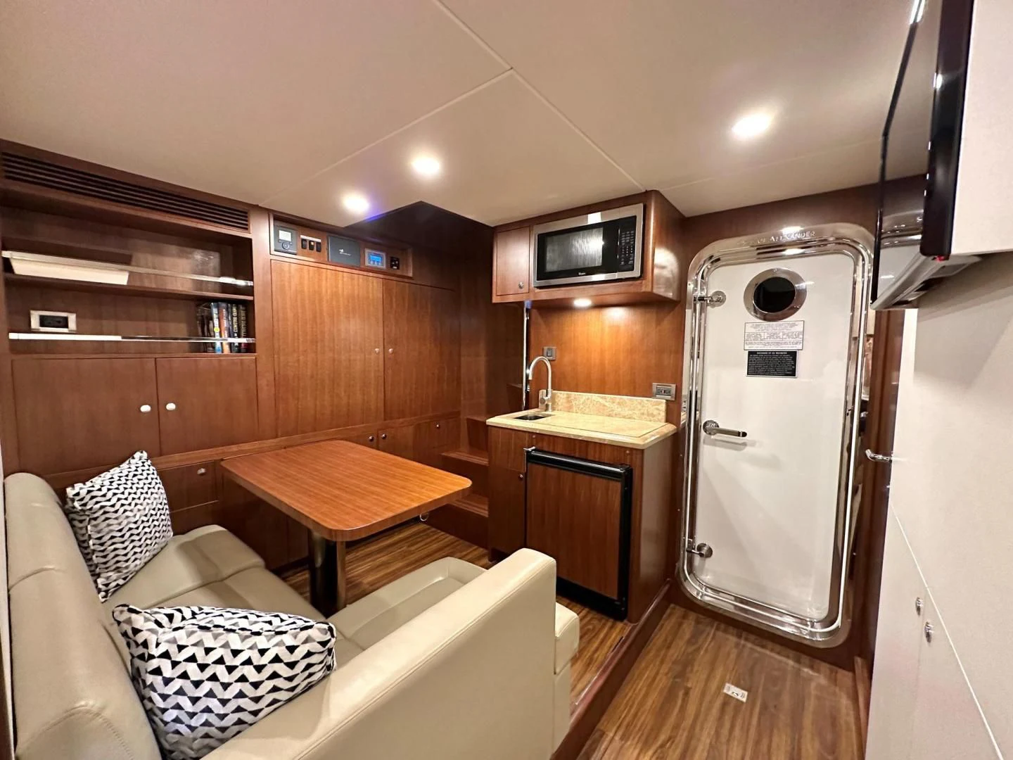 a kitchen with a fridge and a sink aboard CRUMDALE Yacht for Sale