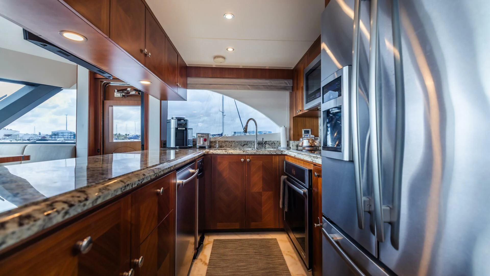 a kitchen with a large refrigerator aboard CRUMDALE Yacht for Sale
