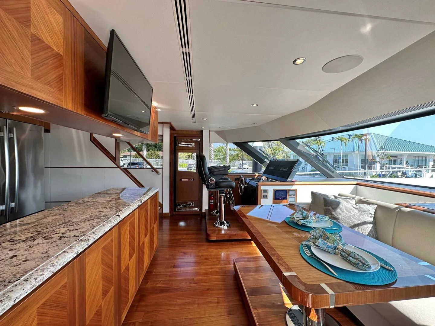 a living room with a large open kitchen and a large deck aboard CRUMDALE Yacht for Sale