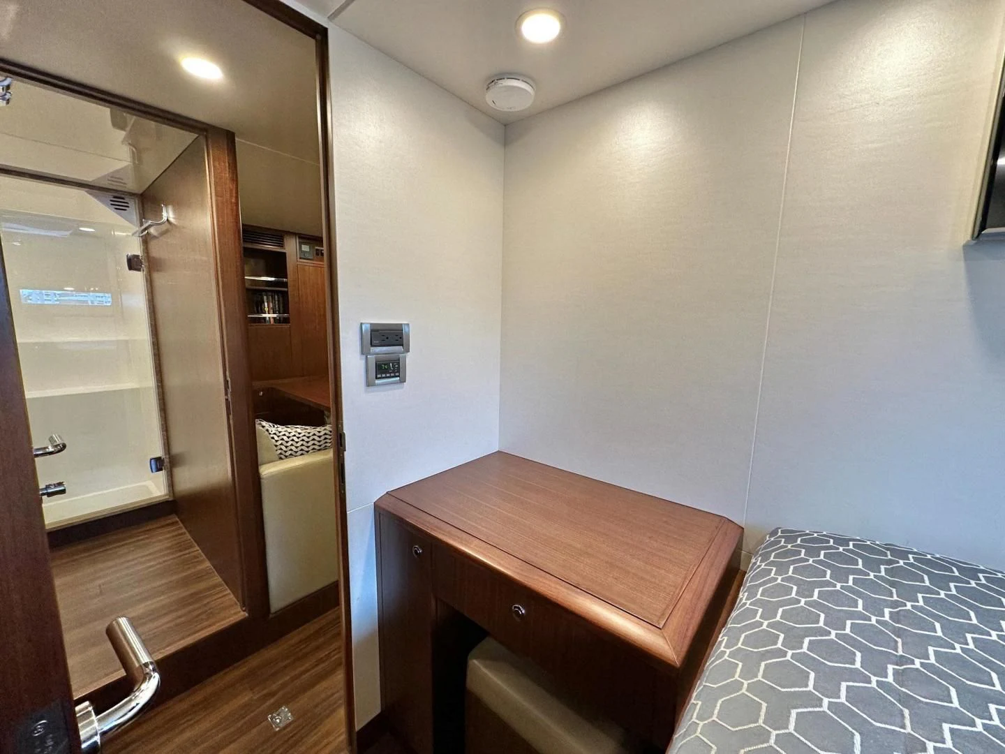 a bedroom with a bed and a desk aboard CRUMDALE Yacht for Sale