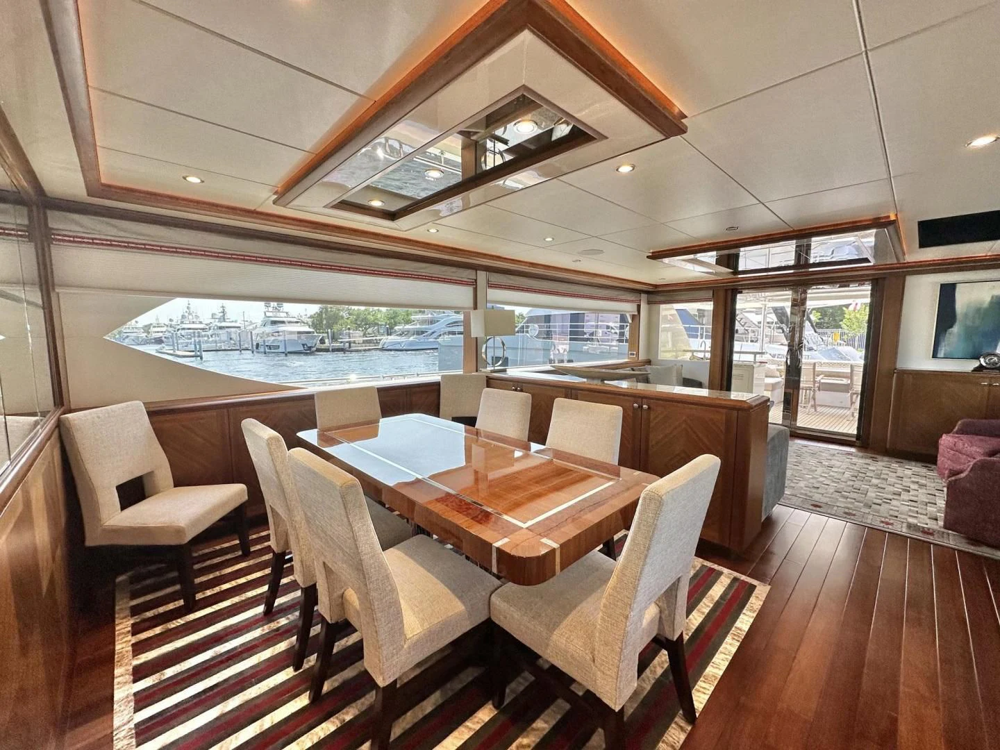 a room with a table chairs and a view of the water aboard CRUMDALE Yacht for Sale