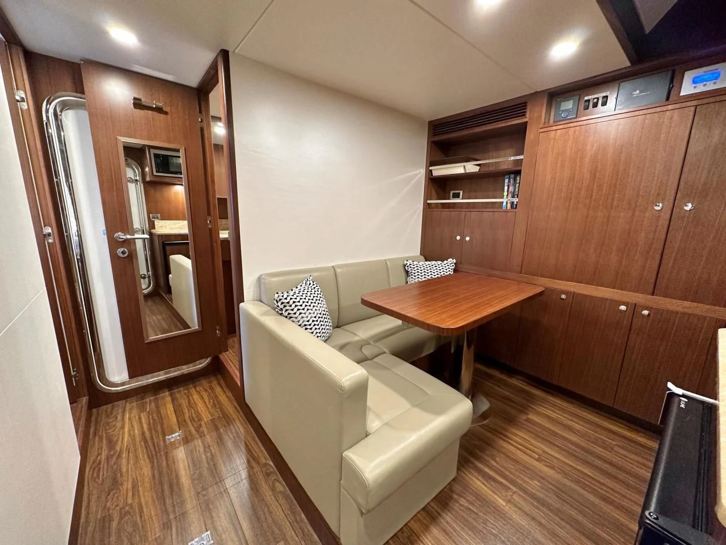 a living room with a table and chairs aboard CRUMDALE Yacht for Sale