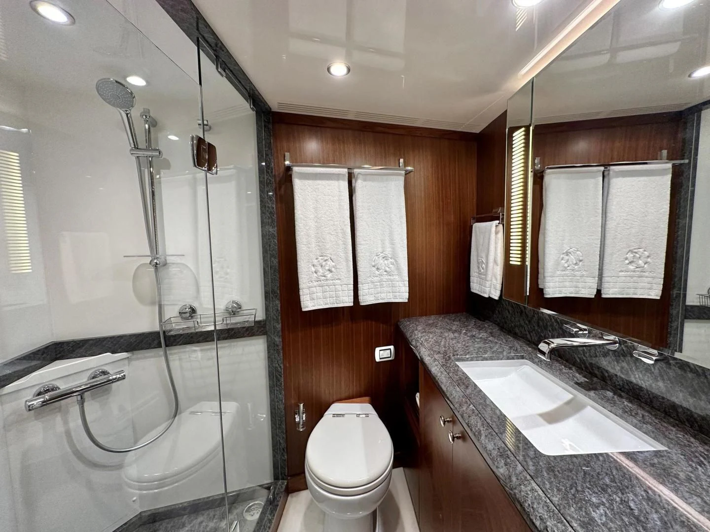 a bathroom with a glass shower aboard CRUMDALE Yacht for Sale