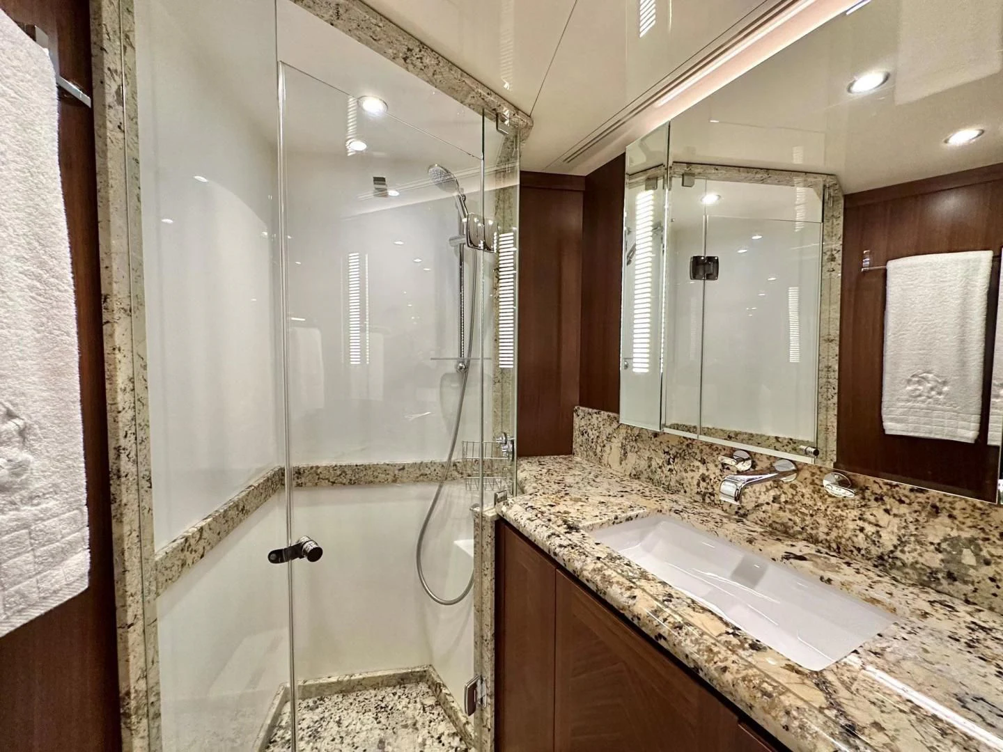 a bathroom with a glass shower aboard CRUMDALE Yacht for Sale