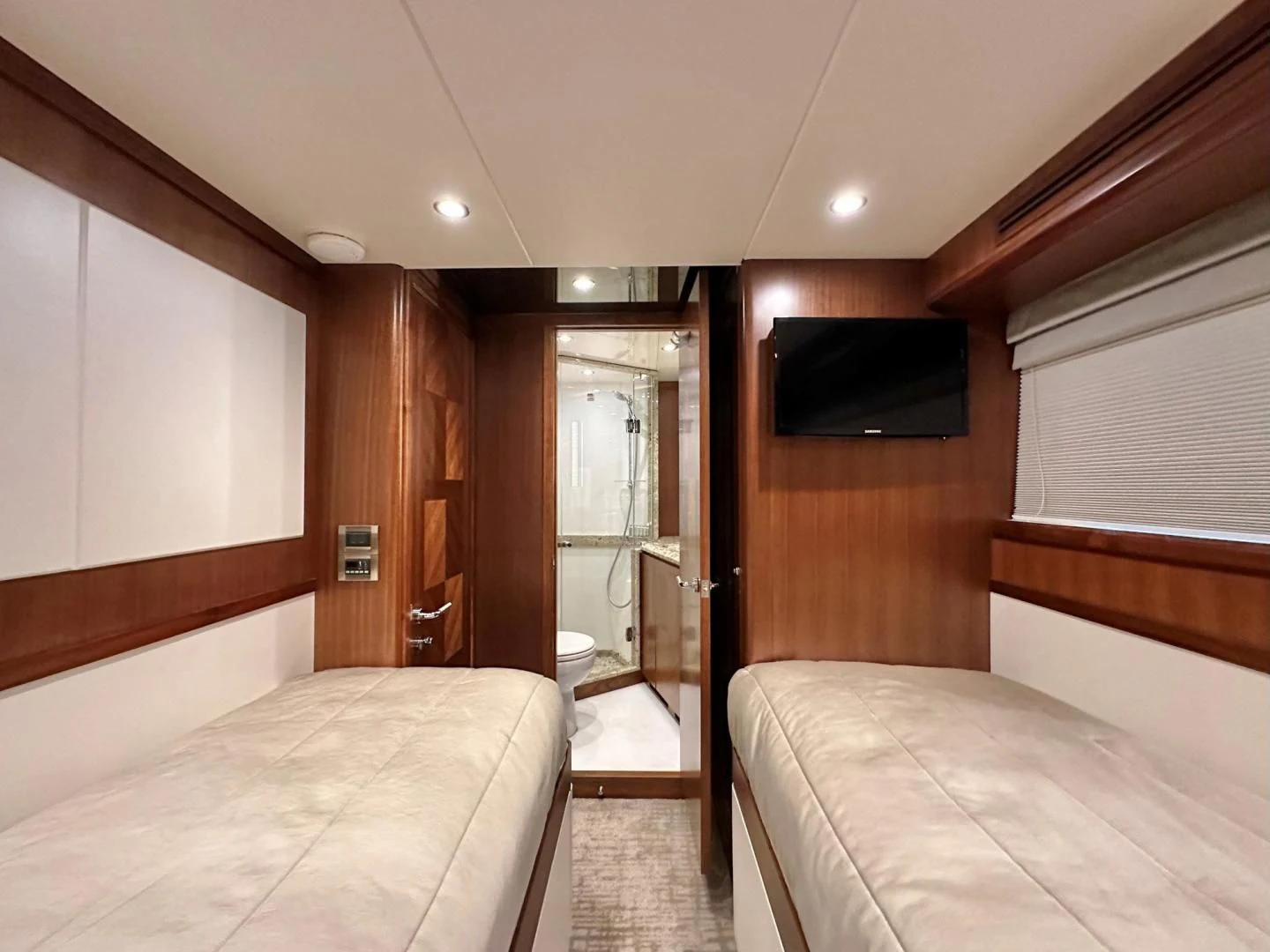 a room with a bed and a television aboard CRUMDALE Yacht for Sale