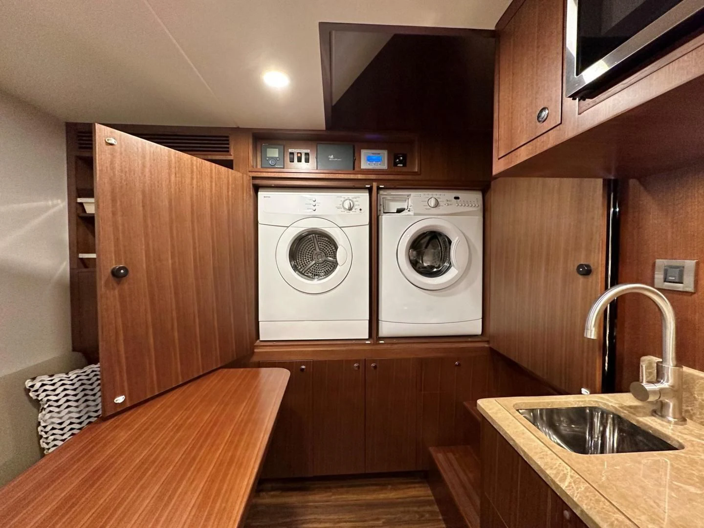 a kitchen with a table and washer and dryer aboard CRUMDALE Yacht for Sale