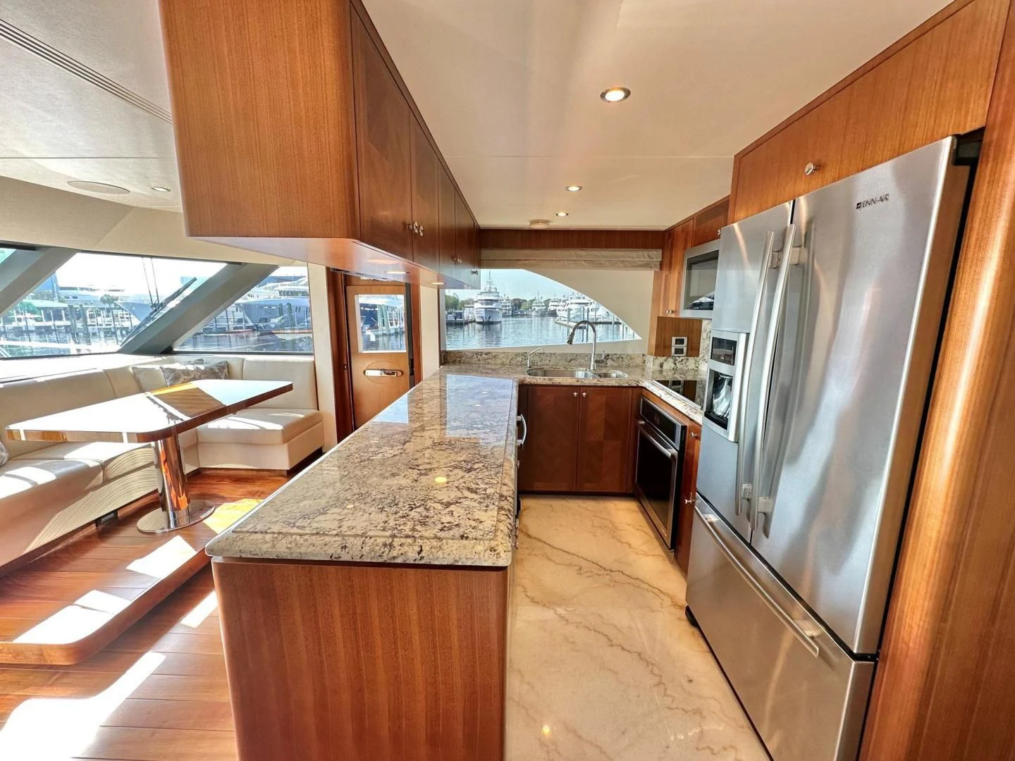 a kitchen with a stainless steel refrigerator aboard CRUMDALE Yacht for Sale