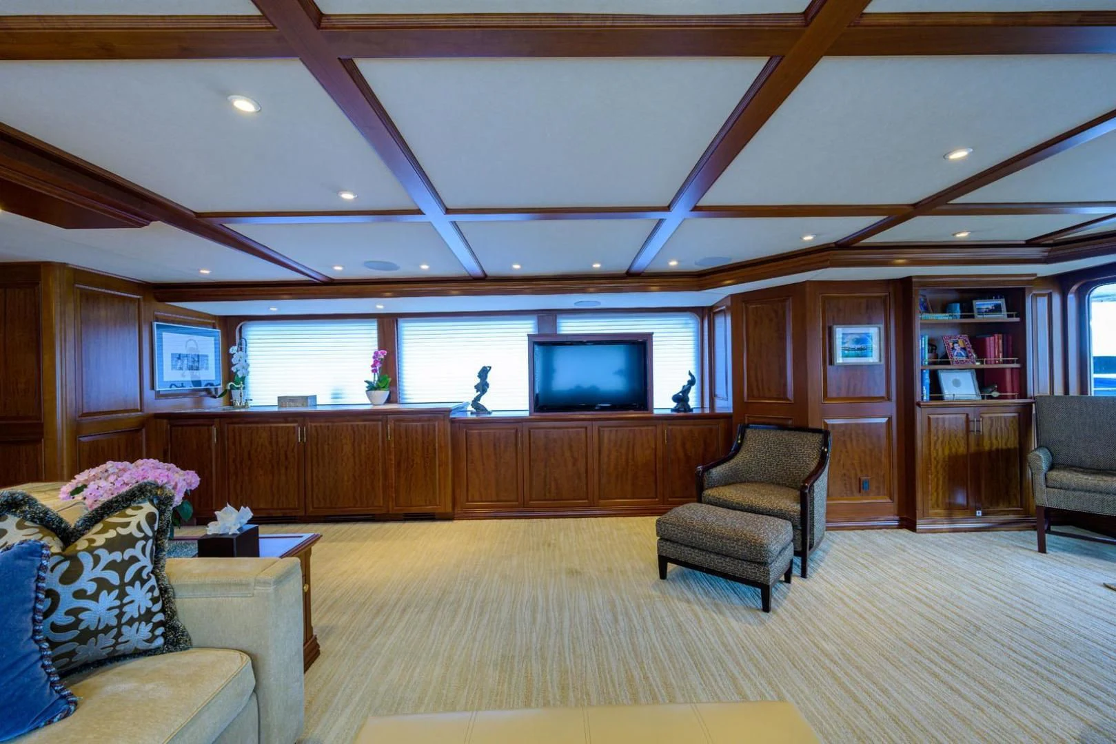 a room with a wood floor and a tv on the wall aboard LEGACY Yacht for Sale